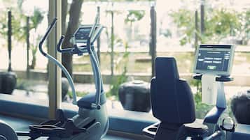 An exercise machine with a digital display and a water bottle holder.