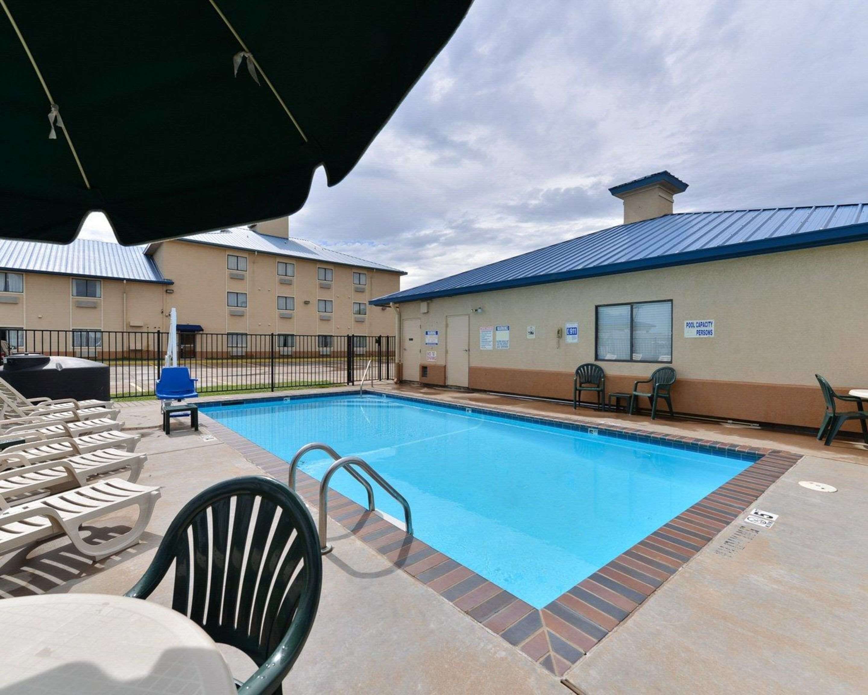Seasonal outdoor pool, open 2:00 PM to 9:00 PM, pool loungers