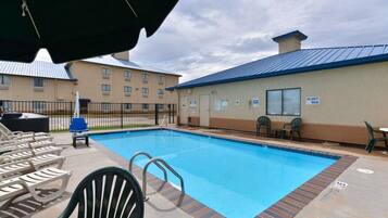 Seasonal outdoor pool, open 2:00 PM to 9:00 PM, pool loungers