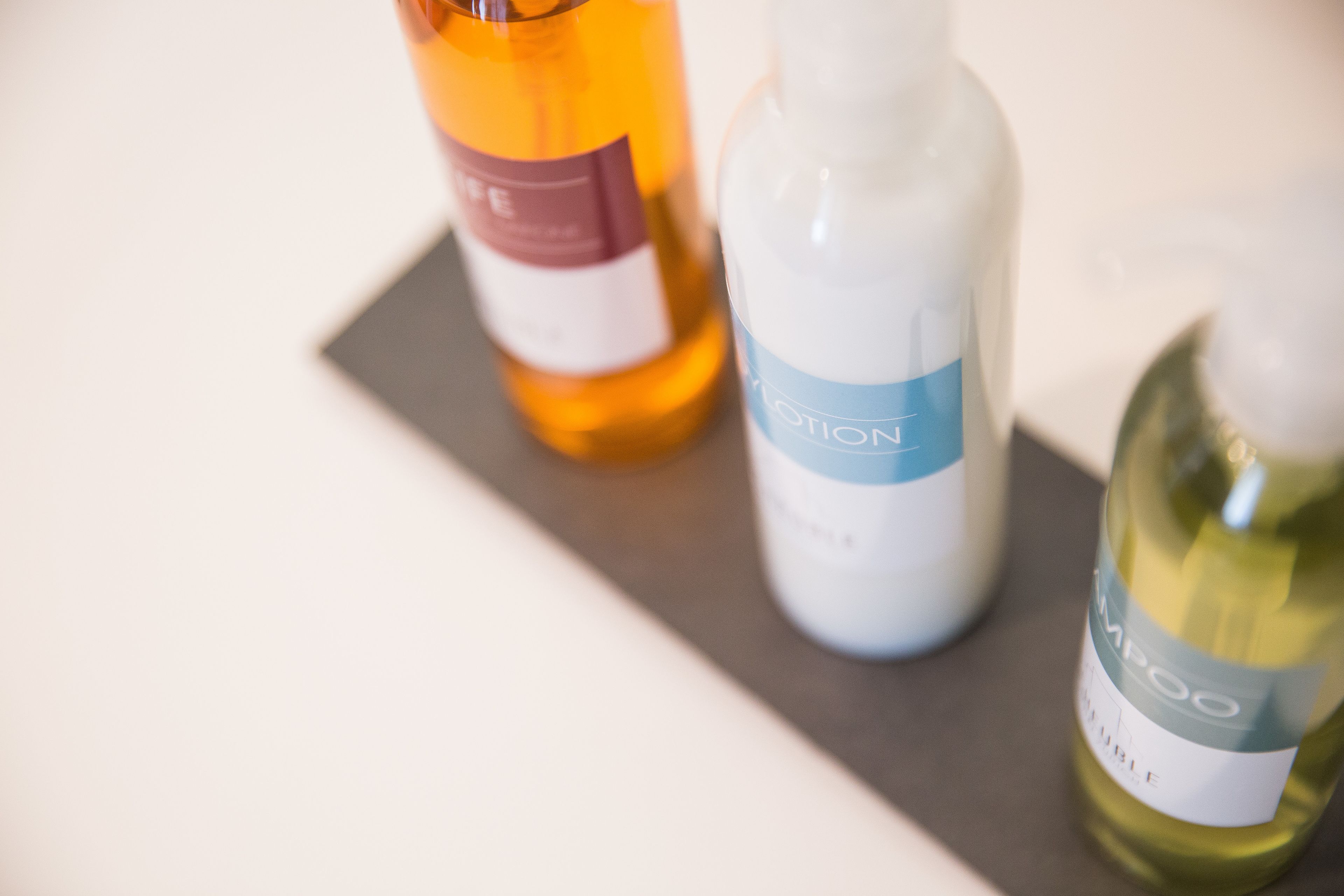 Three bottles of liquid on a tray.