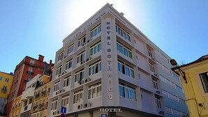 A multi-story hotel with a prominent "HOTEL" sign on the facade.