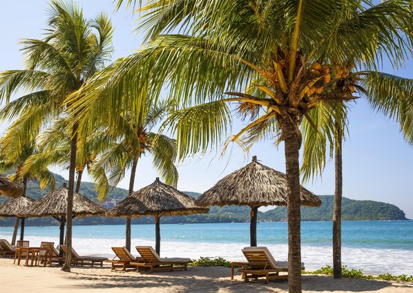 On the beach, sun loungers, beach towels