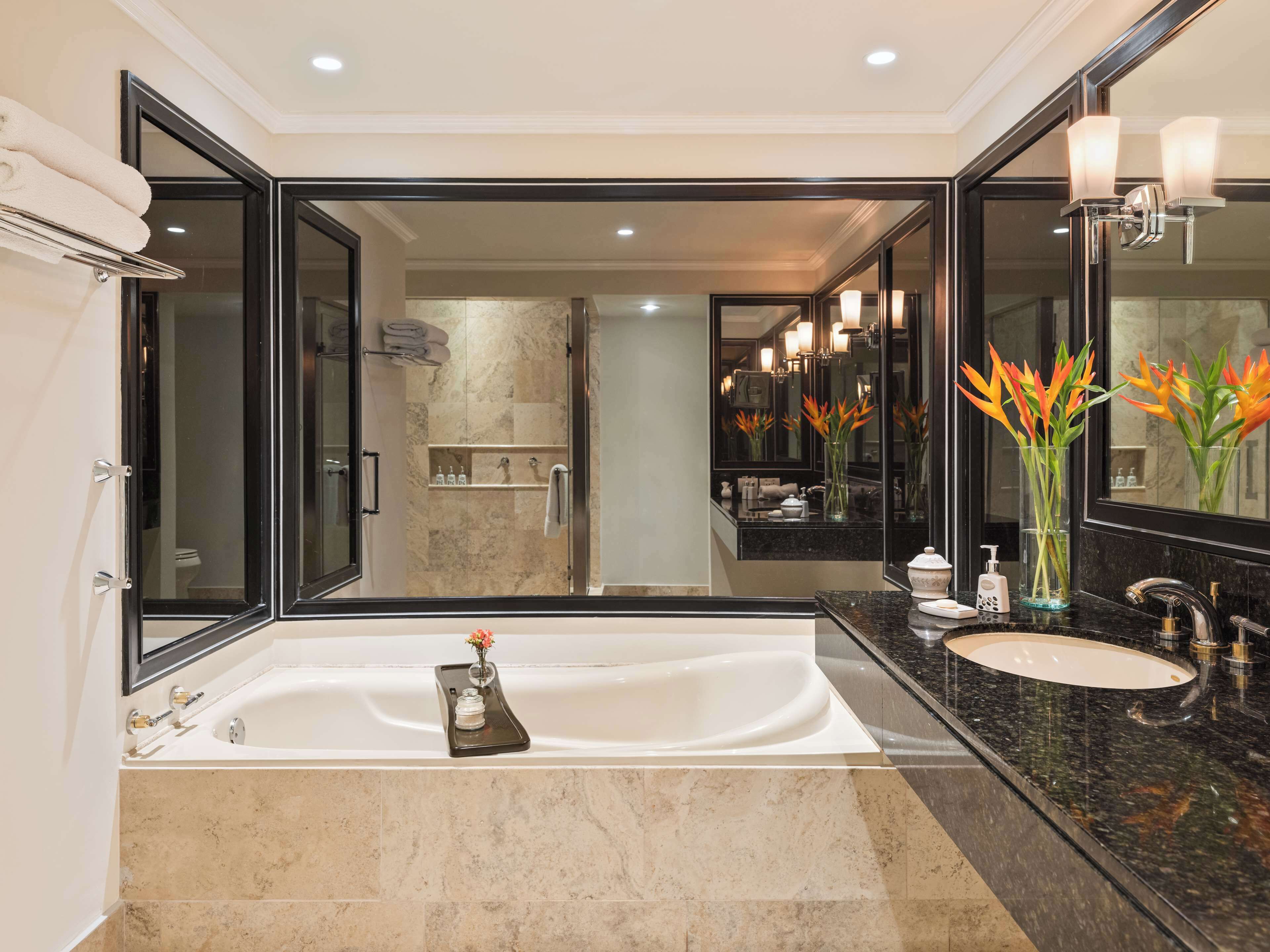 deluxe junior suite | bathroom | separate bathtub and shower, rainfall showerhead, free toiletries