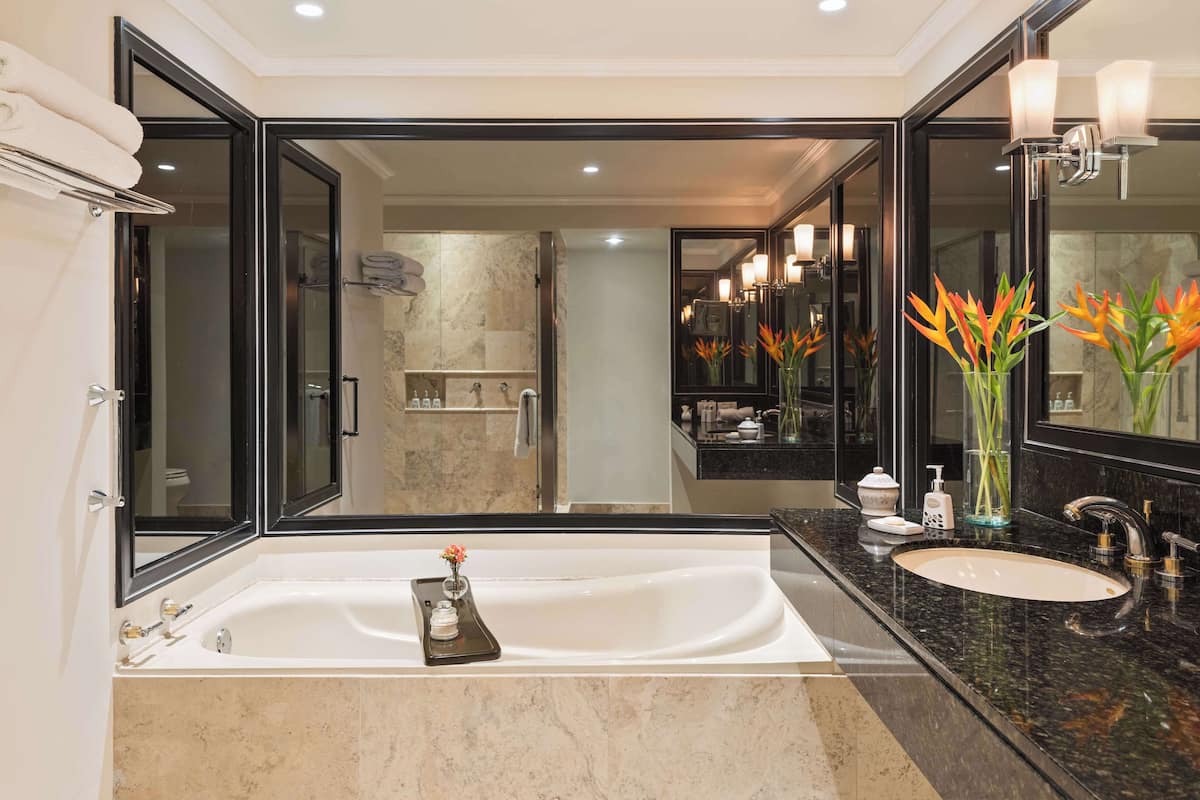 deluxe junior suite | bathroom | separate bathtub and shower, rainfall showerhead, free toiletries