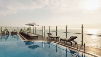 Outdoor pool, open 6:00 AM to 10:00 PM, pool umbrellas