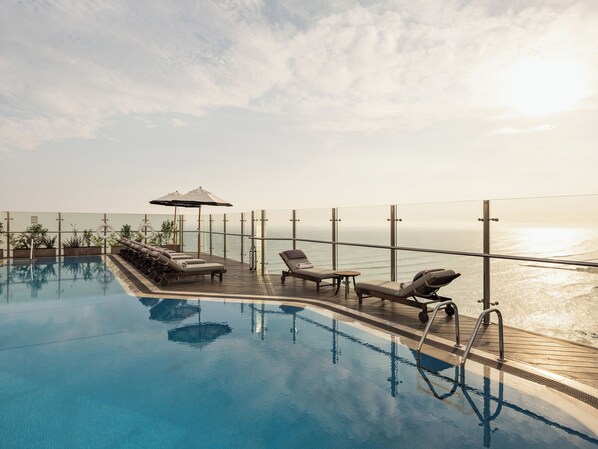 Outdoor pool, open 6:00 AM to 10:00 PM, pool umbrellas