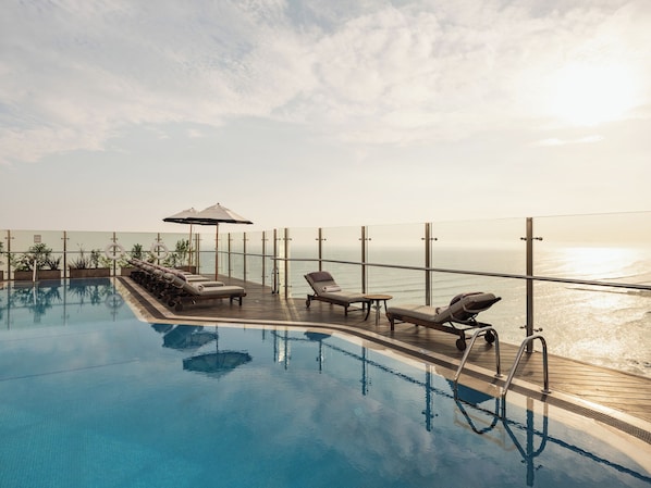 Outdoor pool, open 6:00 AM to 10:00 PM, pool umbrellas