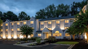 A multi-story hotel with a symmetrical facade, large windows, and a central entrance with a covered porch. - Microtel Inn & Suites by Wyndham Atlanta/Buckhead Area (Atlanta)