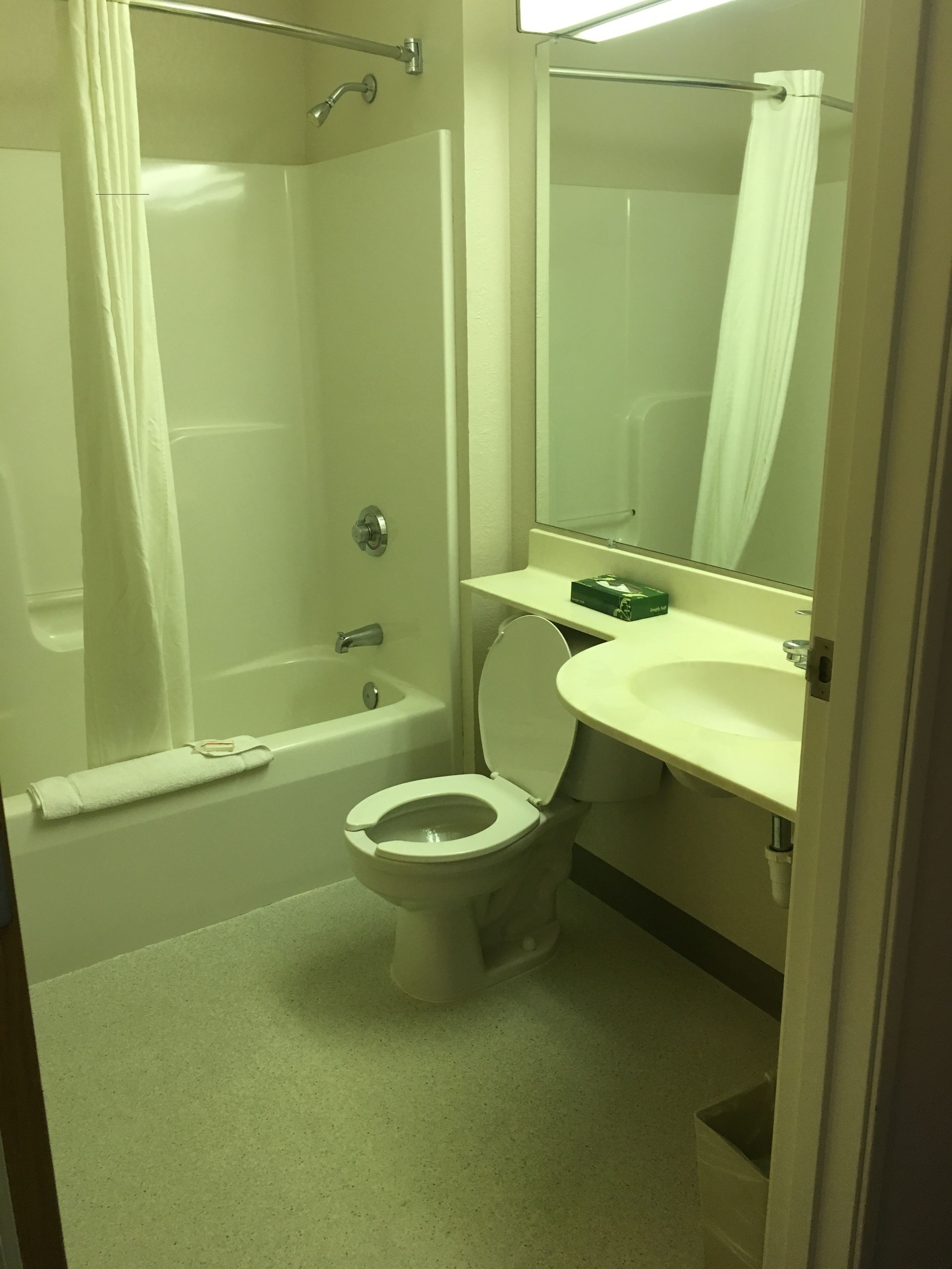 A bathroom with a bathtub, toilet, and sink.