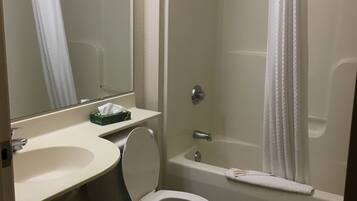 A bathroom with a toilet, sink, and bathtub.