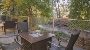 An outdoor patio with a fire feature, metal chairs, and a table. - La Quinta Inn by Wyndham Missoula (Missoula)