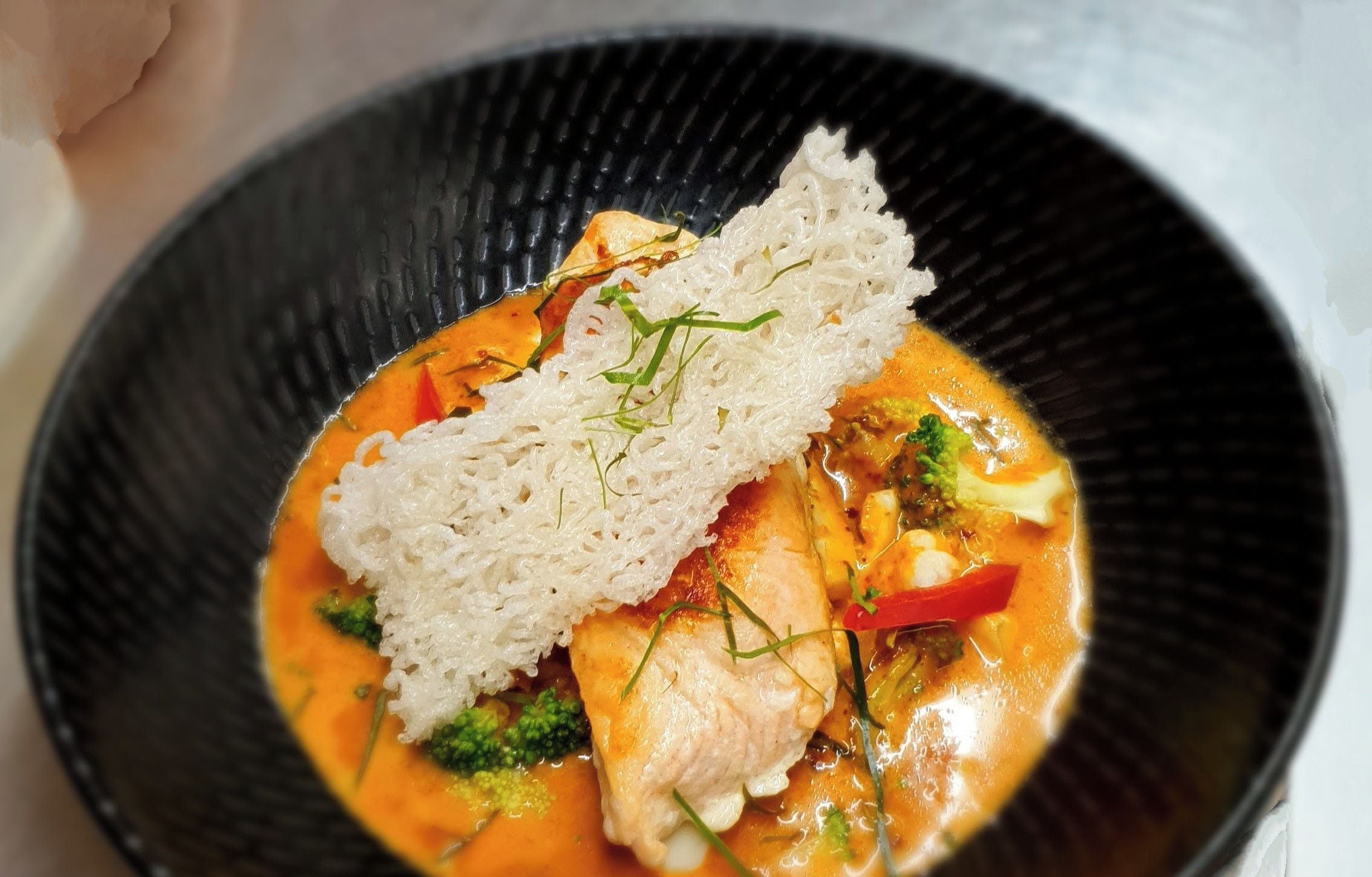 A bowl of Choo-Chee Salmon with rice and vegetables.