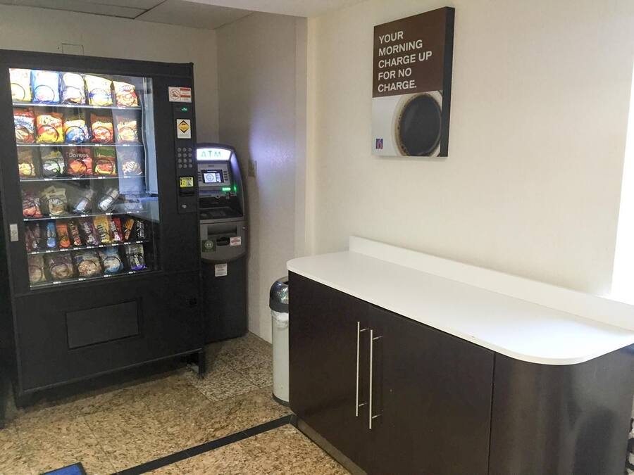 A vending machine with snacks and an ATM.