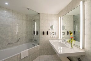 Bathtub, eco-friendly toiletries, hair dryer, towels