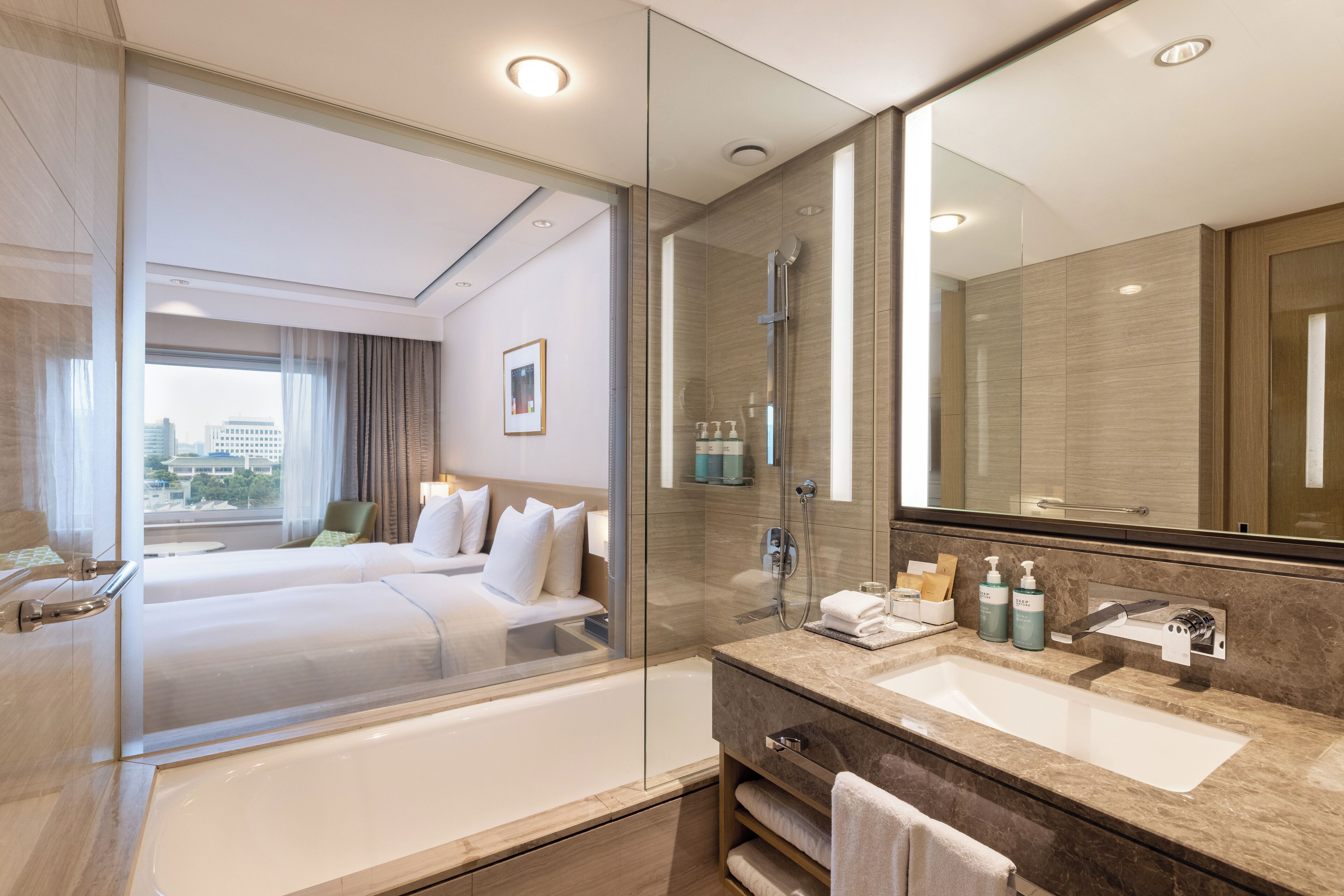 deluxe room, 2 single beds | bathroom | eco-friendly toiletries, hair dryer, bathrobes, slippers