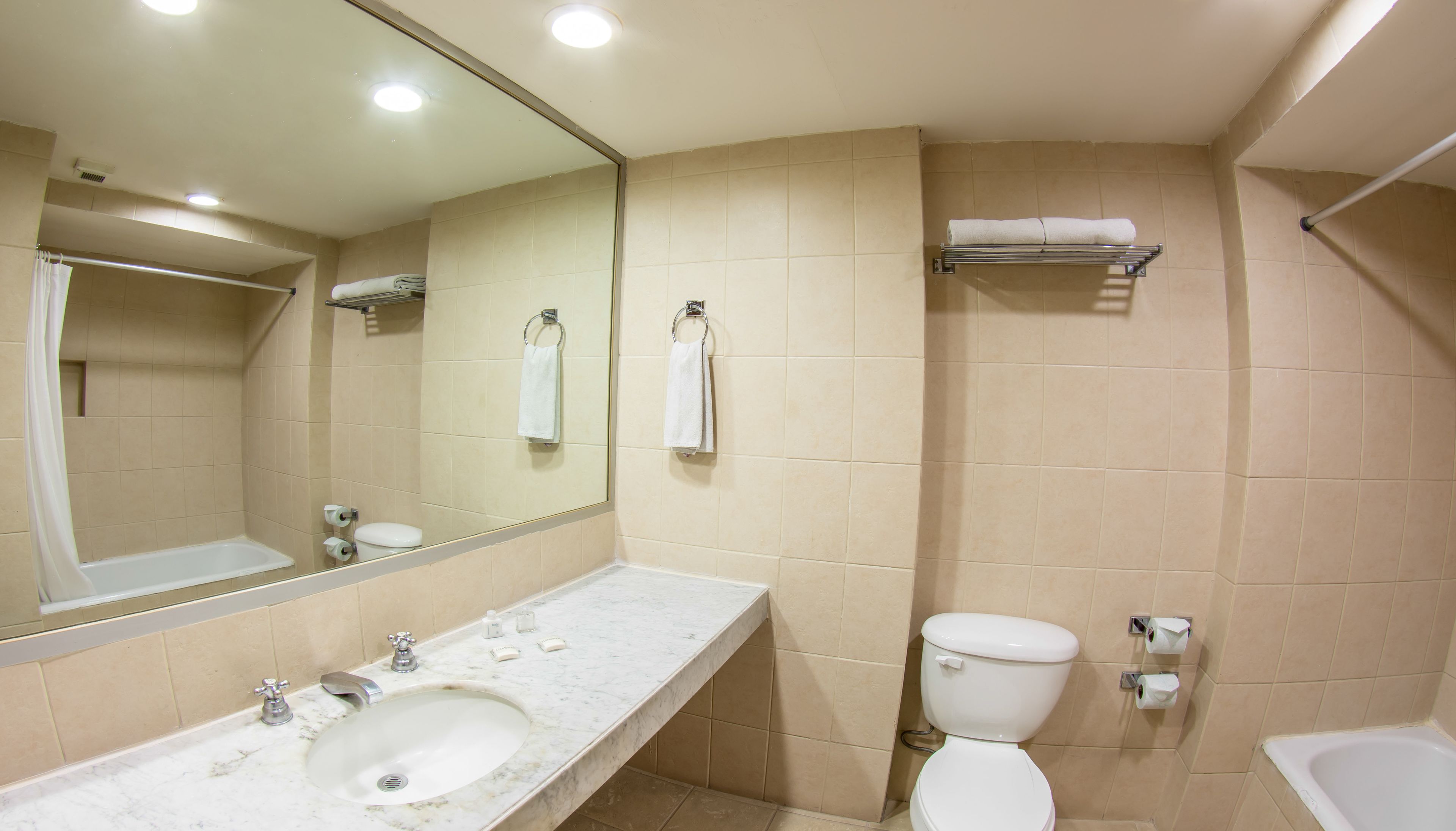 A bathroom with a sink, toilet, and bathtub.