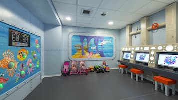 Children can play and learn in this vibrant play area with a colorful underwater mural and interactive features.