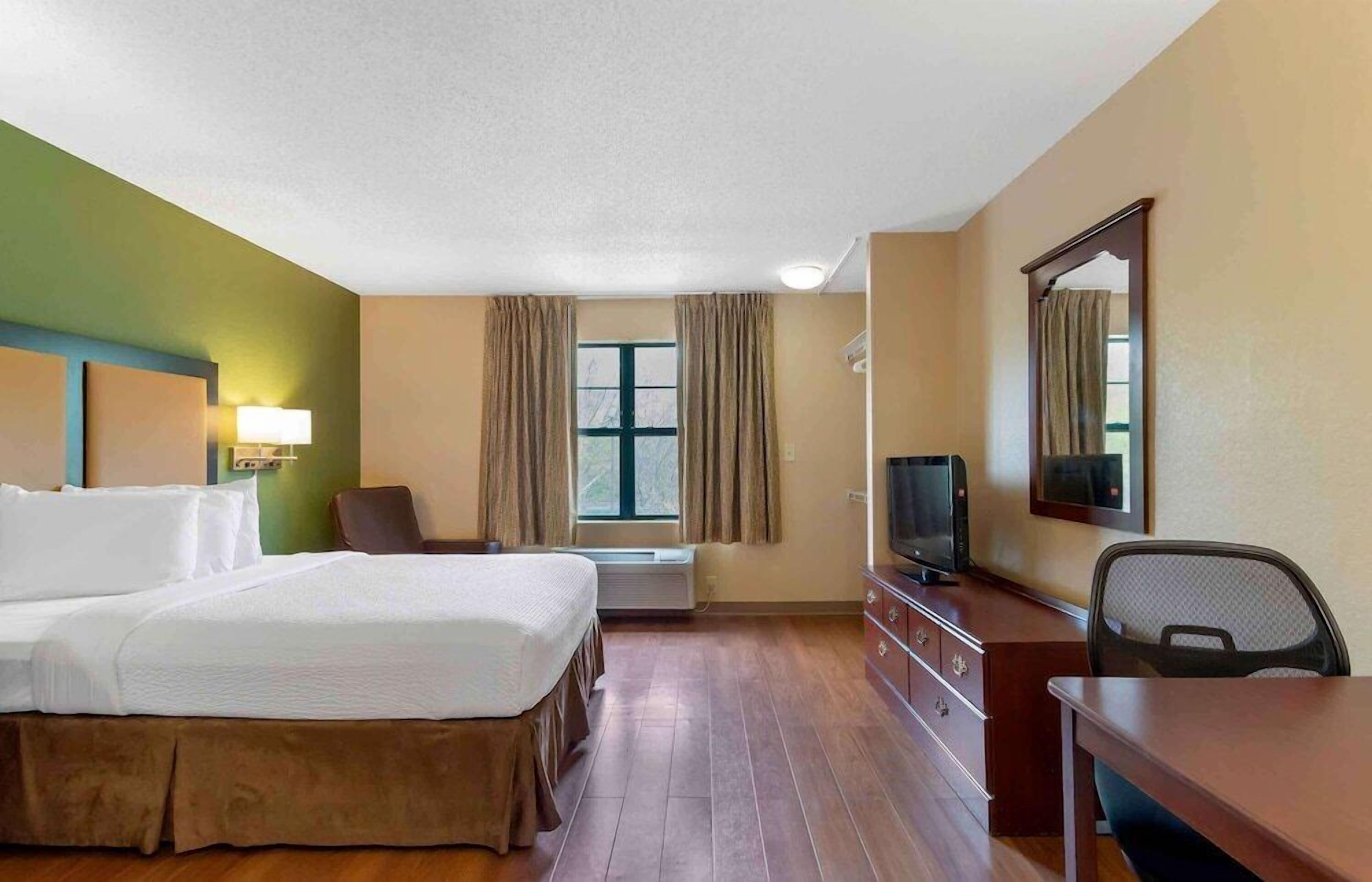 Premium bedding, desk, laptop workspace, iron/ironing board
