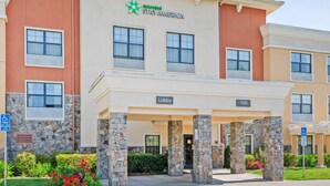 A multi-story hotel with a stone facade, a 'Lobby' sign, and a '100' sign indicating the building's address. - Extended Stay America Suites Santa Rosa North (Santa Rosa)