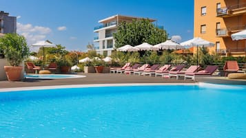 Seasonal outdoor pool, open 10:00 AM to 6:00 PM, pool umbrellas