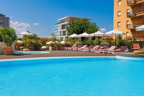 Seasonal outdoor pool, open 10:00 AM to 6:00 PM, pool umbrellas