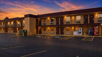 A motel with multiple rooms, a parking lot, and a vending machine.
