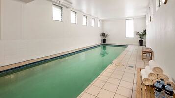 Relax by the pool, surrounded by natural light and lush greenery.