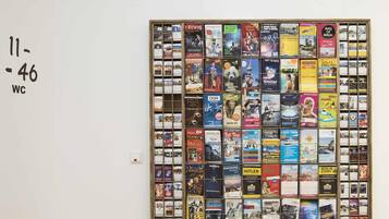 A wall with a grid of postcards and brochures, each featuring various travel destinations and activities.