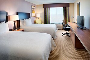 A hotel room with two beds, a desk with a computer, a chair, a lamp, and a TV. - Hilton Garden Inn Hartford North/Bradley Int'l Airport (Windsor)