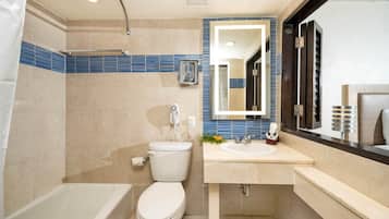 A modern bathroom with a bathtub, toilet, and sink.