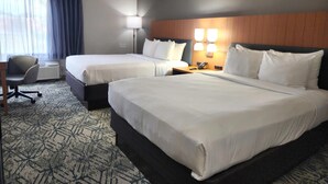 A hotel room with two beds, a desk, and a chair. There is a lamp on the desk and a phone on the nightstand. - Country Inn & Suites by Radisson, Dahlgren-King George, VA (King George)