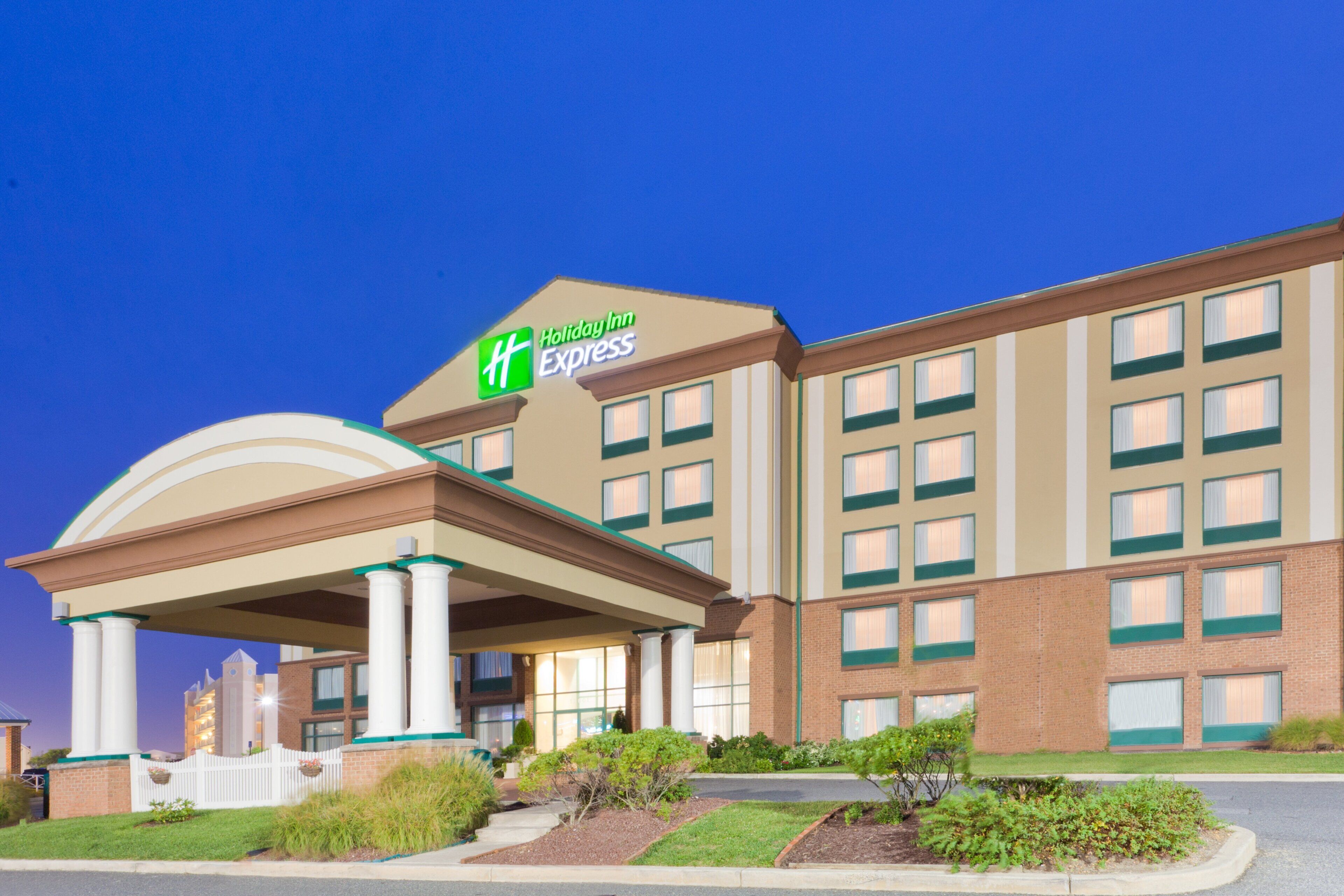 A Holiday Inn Express hotel with a large entrance, multiple windows, and a covered area with columns.