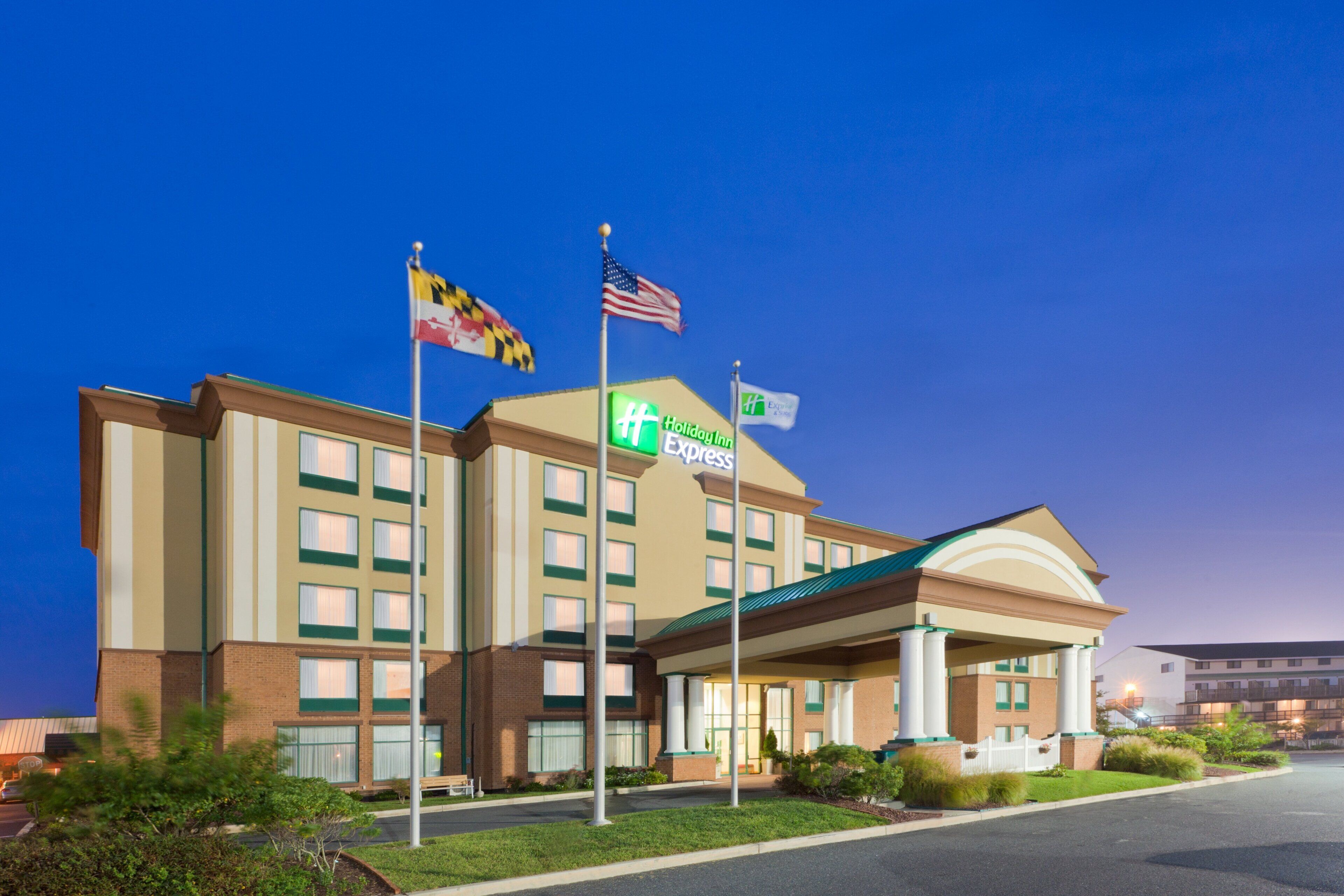 A Holiday Inn Express hotel with a brick facade, multiple windows, and a green awning.