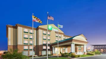 A Holiday Inn Express hotel with a brick facade, multiple windows, and a green awning.