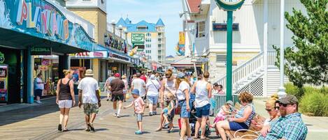 A boardwalk with shops and a clock.