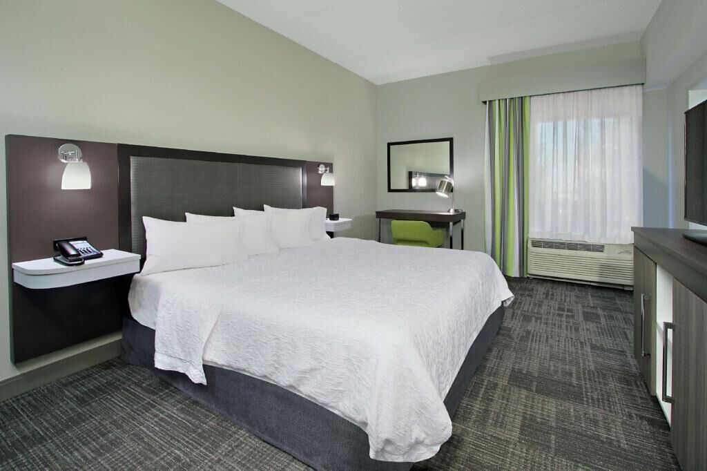 Premium bedding, desk, laptop workspace, blackout drapes
