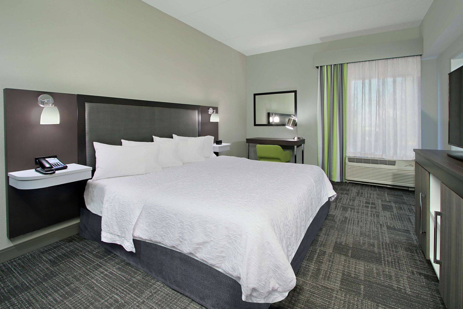 Premium bedding, desk, laptop workspace, blackout drapes