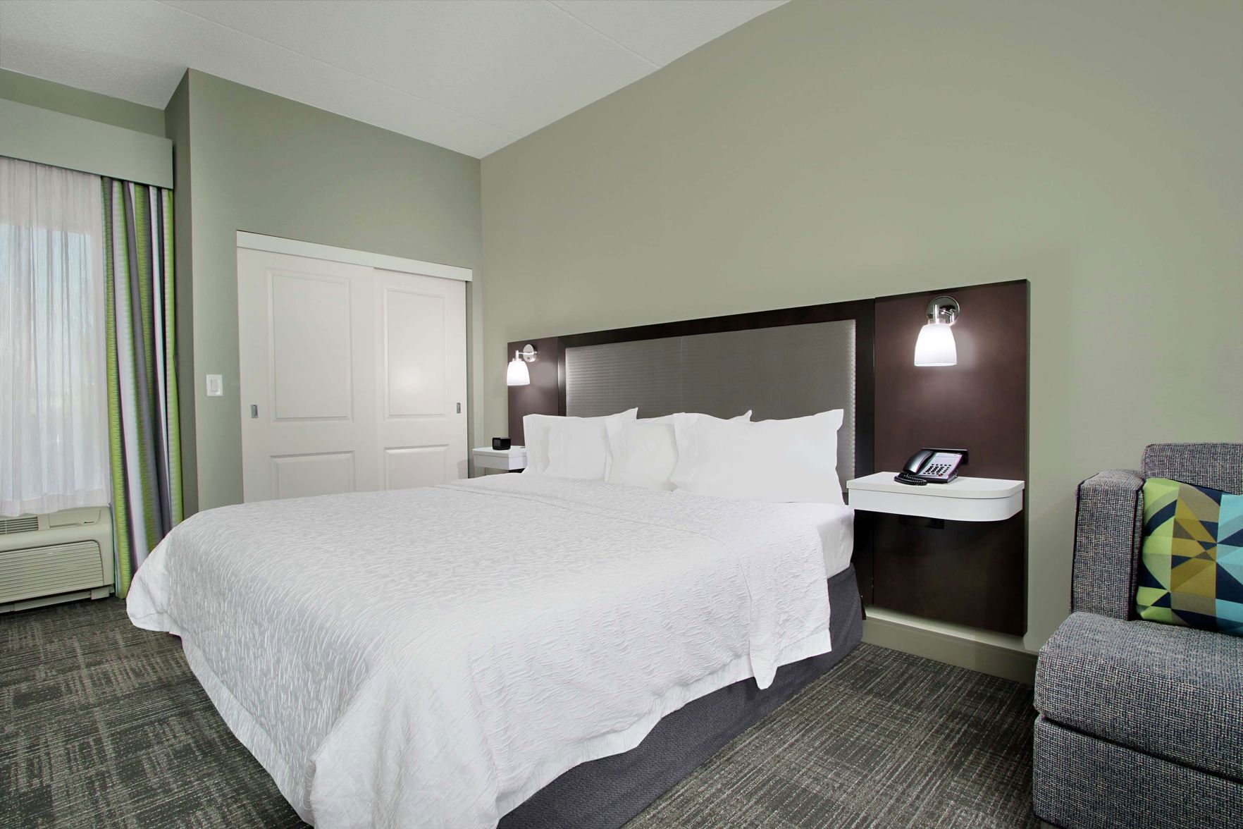 Premium bedding, desk, laptop workspace, blackout drapes