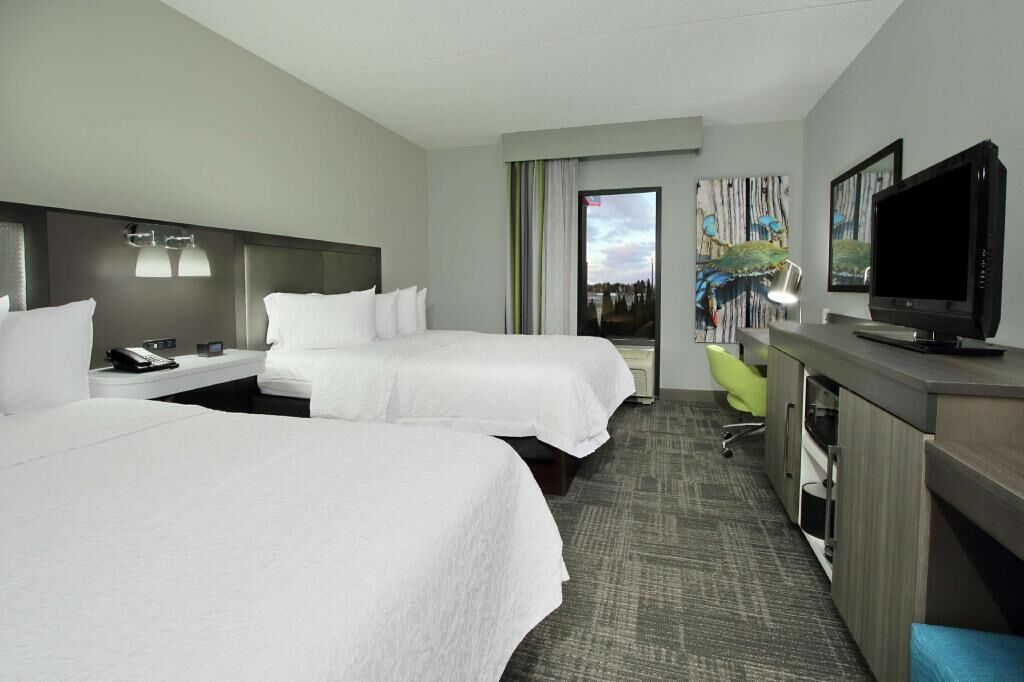 Premium bedding, desk, laptop workspace, blackout drapes