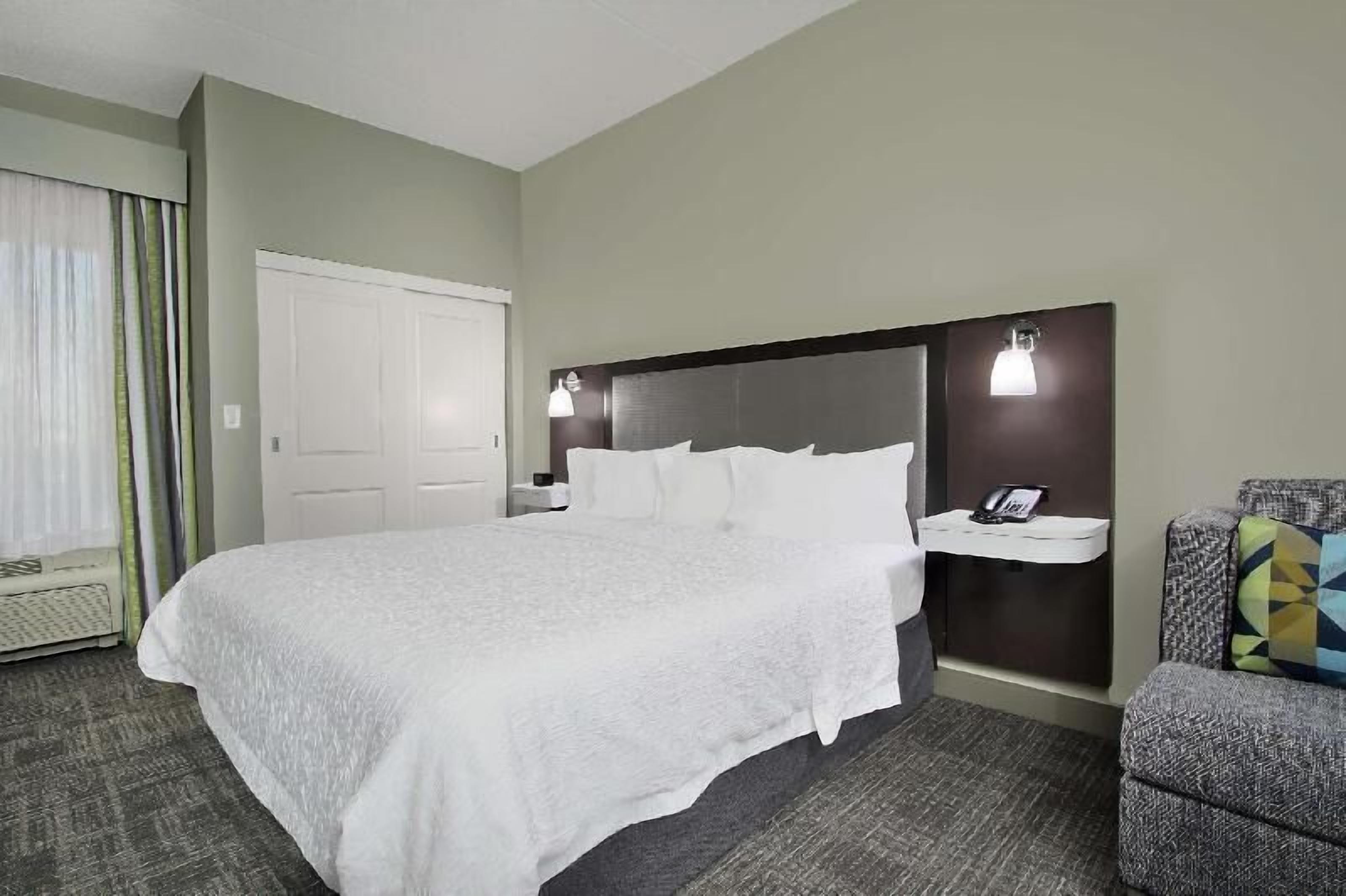 Premium bedding, desk, laptop workspace, blackout drapes