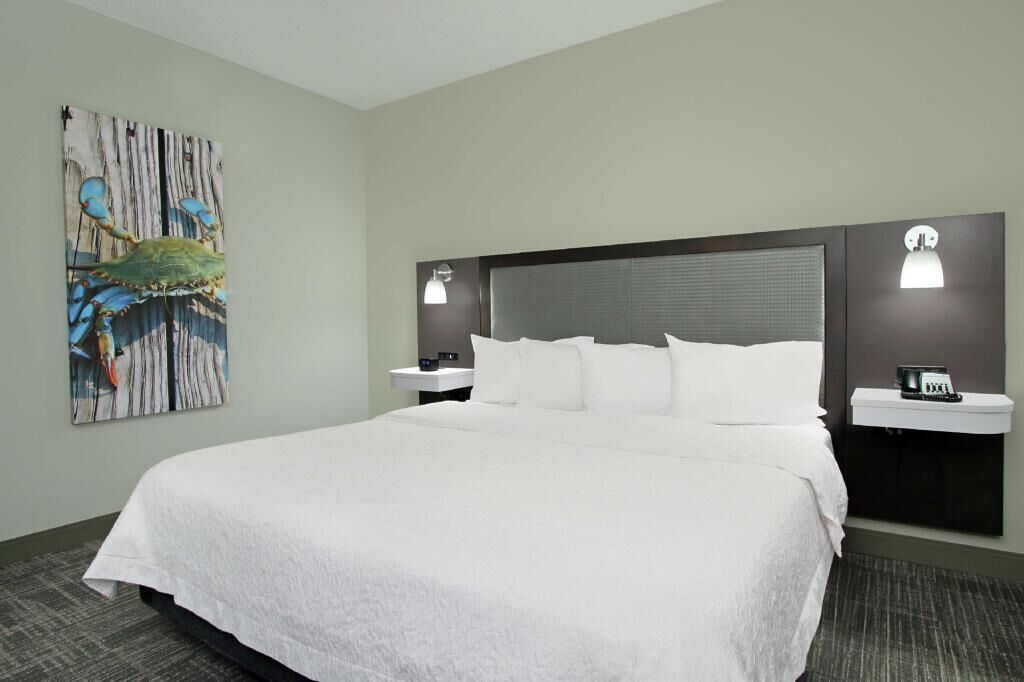 Premium bedding, desk, laptop workspace, blackout drapes