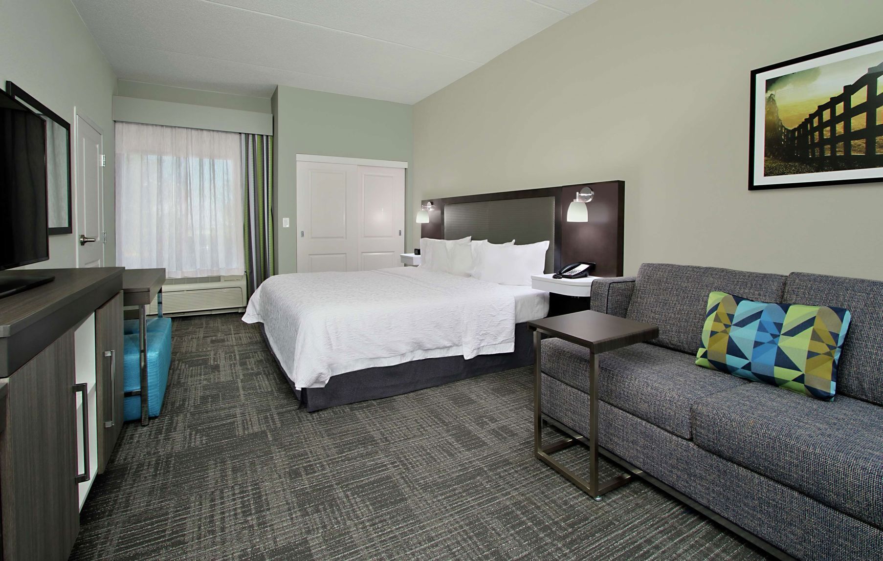 Premium bedding, desk, laptop workspace, blackout drapes