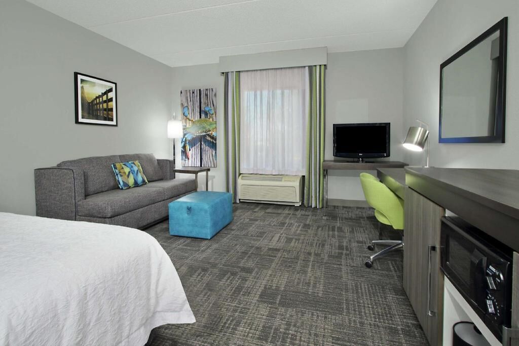 Premium bedding, desk, laptop workspace, blackout drapes
