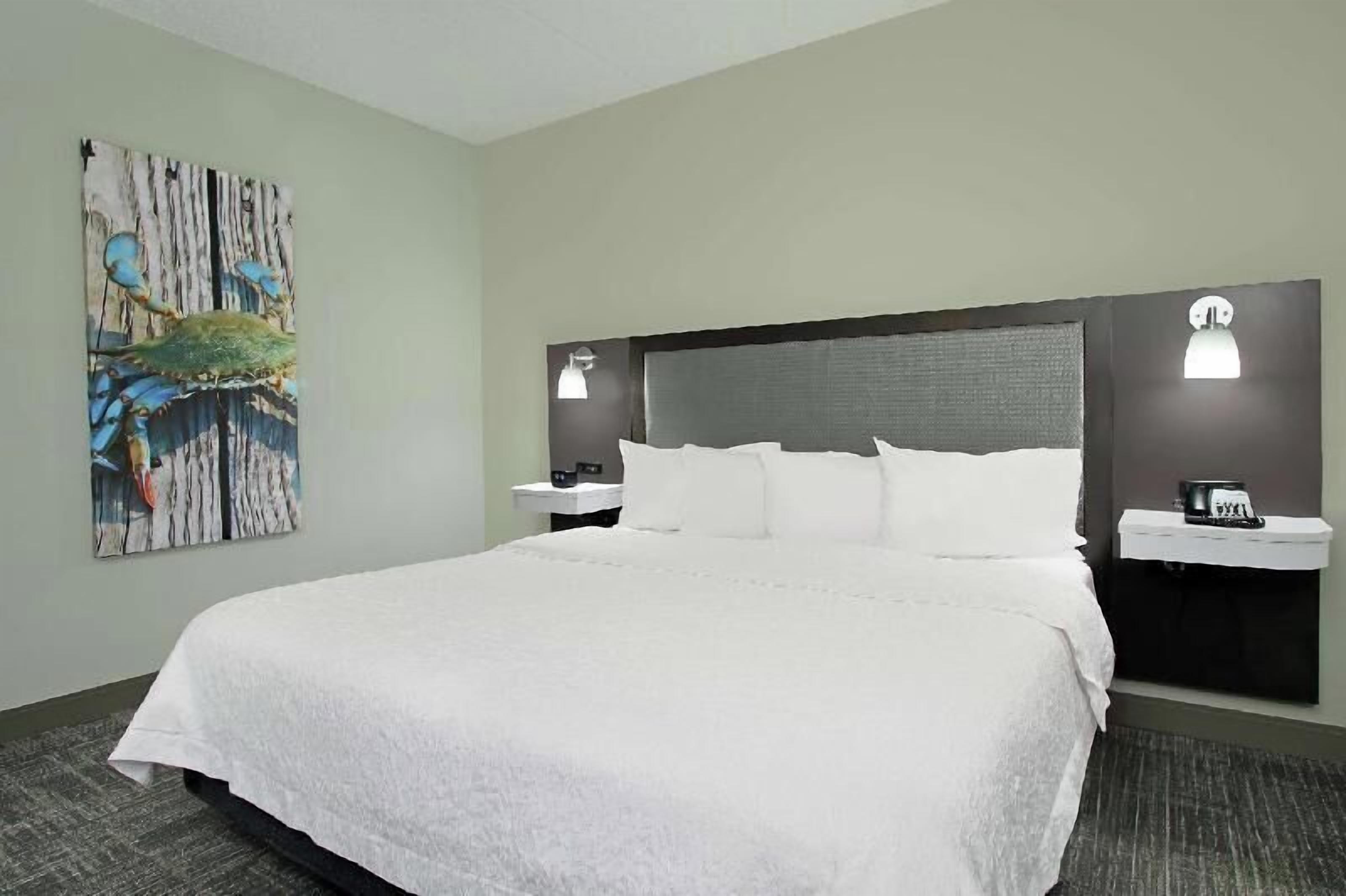 Premium bedding, desk, laptop workspace, blackout drapes