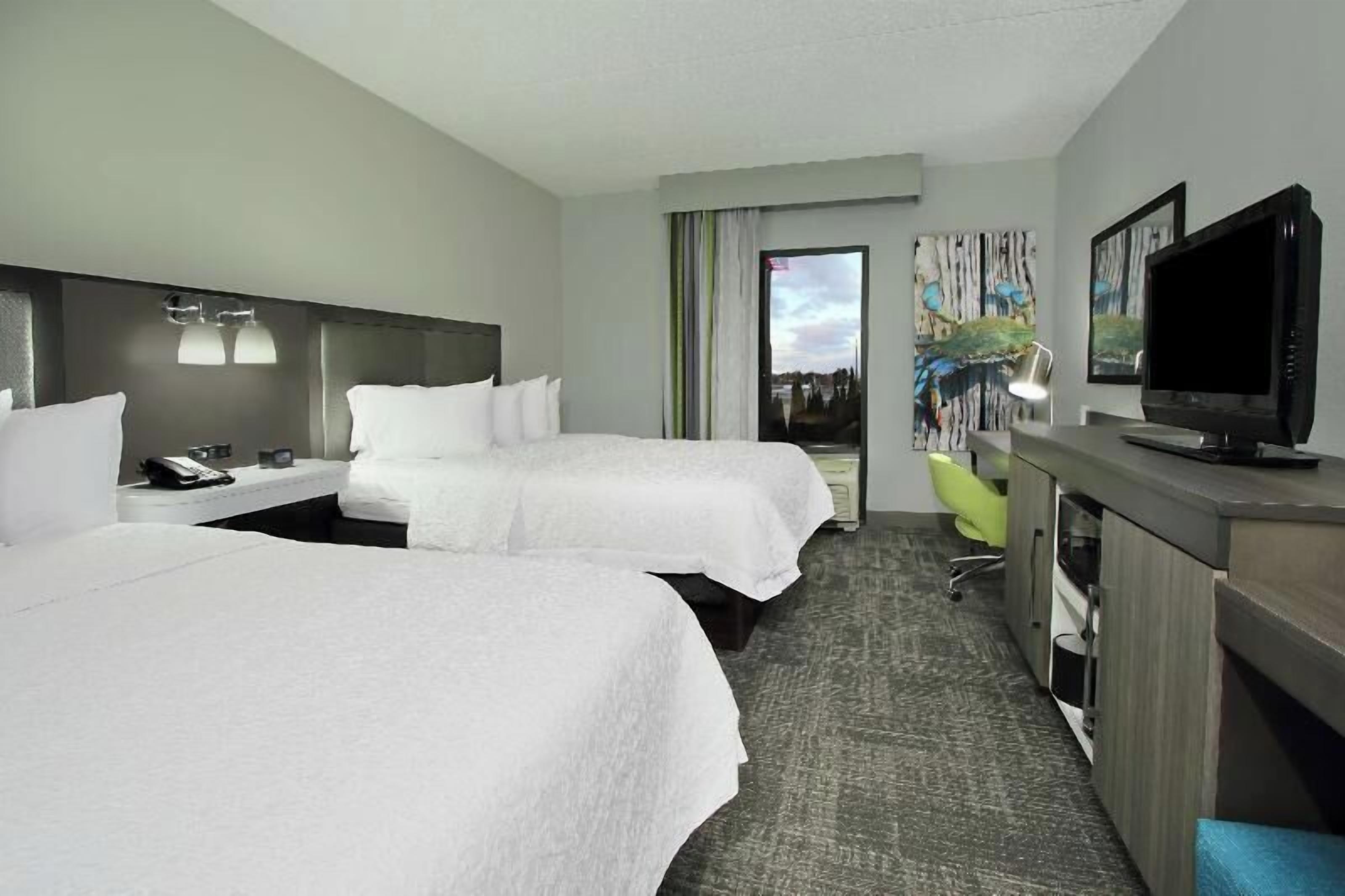 Premium bedding, desk, laptop workspace, blackout drapes