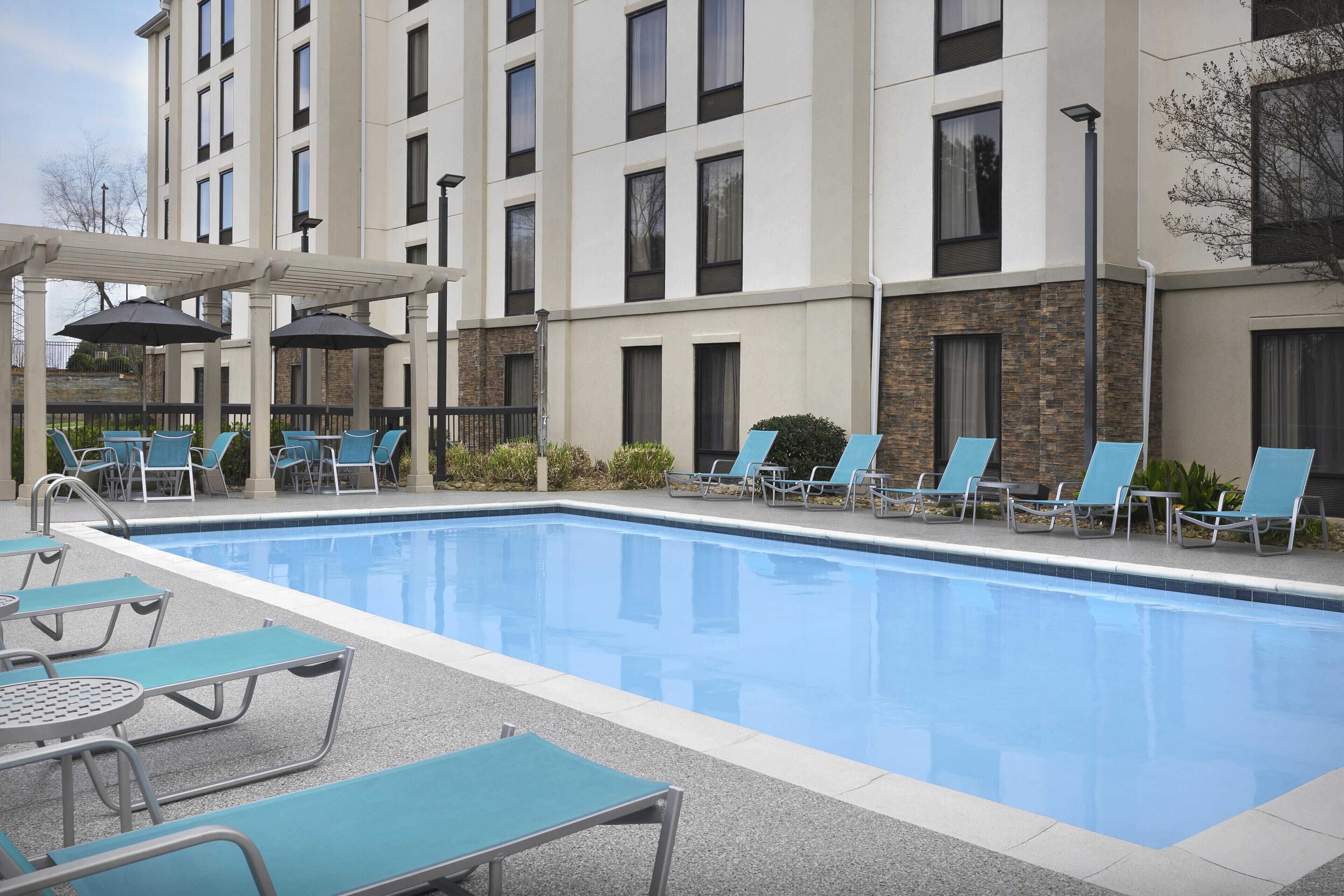 Seasonal outdoor pool, open 10:00 AM to 10:00 PM, pool umbrellas