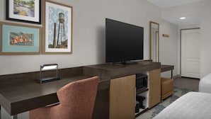 A hotel room with a flat-screen TV, a desk with a chair, a bed, and framed pictures on the wall. - Hampton Inn & Suites Greenville/Spartanburg I-85, SC (Duncan)