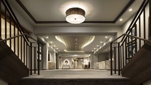 A grand staircase leading to a reception area with a modern design, featuring a marble floor and a unique ceiling light fixture. - Hyatt Regency Tamaya Resort & Spa (Santa Ana Pueblo)