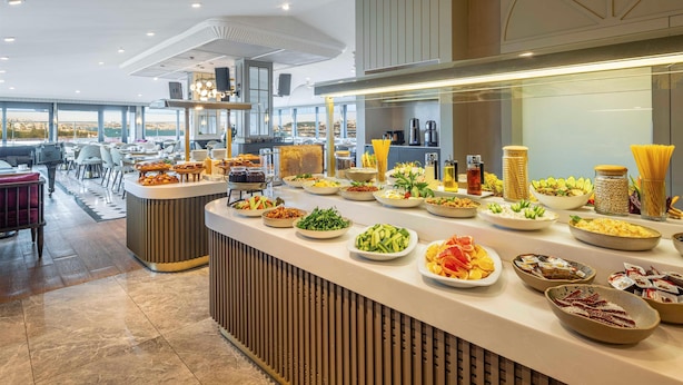 A buffet setup with various food items and a modern interior design. - AHC Old City Hotel (Istanbul)