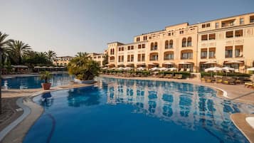 Indoor pool, outdoor pool, pool umbrellas, pool loungers